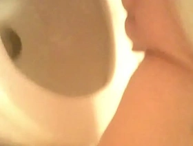 Girl with hairless pussy caught peeing on bathroom camera
